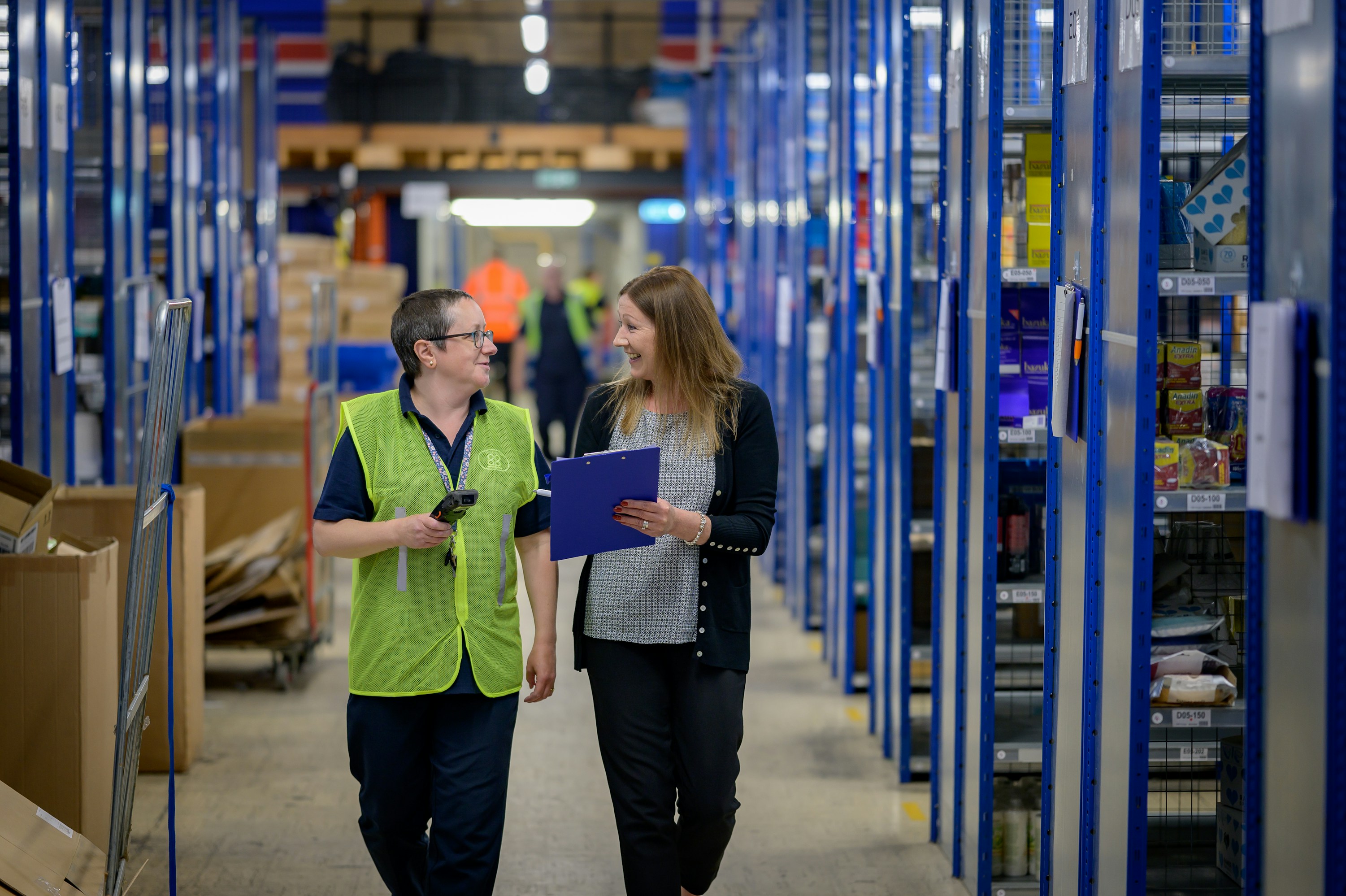 Manufacturing professionals collaborating in modern warehouse facility